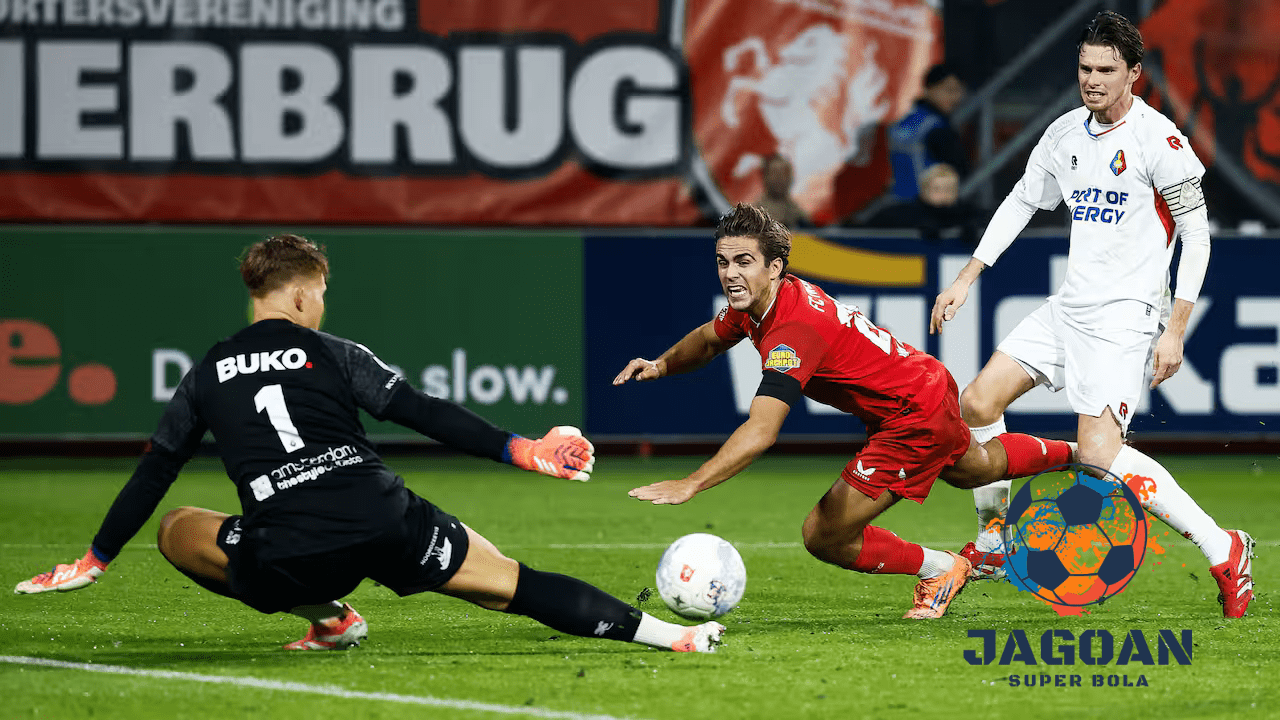 Kiper melakukan penyelamatan penting saat pemain lawan berusaha mencetak gol dalam pertandingan sepak bola Eredivisie